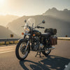 Classic motorcycle with saddlebags parked on a mountain road at sunset, Rawtorque style