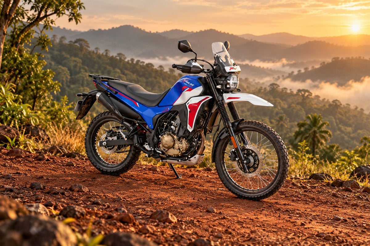 Hero Xpulse 210 in blue, white and red parked on a red-dirt trail in the Western Ghats at sunset