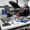 Automotive detailing and lighting products on workbench with sports car in Rawtorque garage