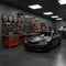 Matte black BMW coupe in high-end auto performance garage with precision parts wall, RawTorque