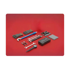 Automotive and motorcycle mechanic hand tools, gloves, and tuning equipment on red background