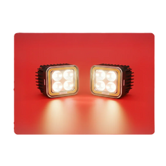 Pair of square LED automotive lights with heatsink, illuminated on red background, RawTorque parts