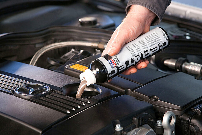 Liqui Moly Cera Tec being poured into the oil filler neck of a Mercedes engine