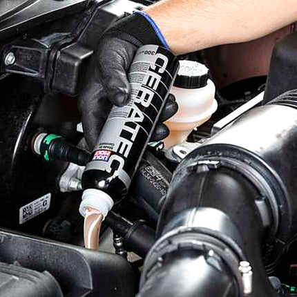 Liqui Moly Cera Tec being poured into the oil filler of a car engine