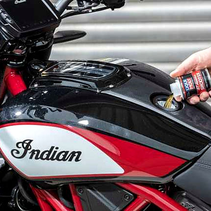 Liqui Moly Motorbike 4T Shooter being poured into a motorcycle fuel tank
