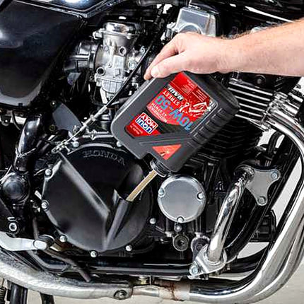 Liqui Moly Motorbike 4T Synth 10W-50 Street Race being poured into a motorcycle engine