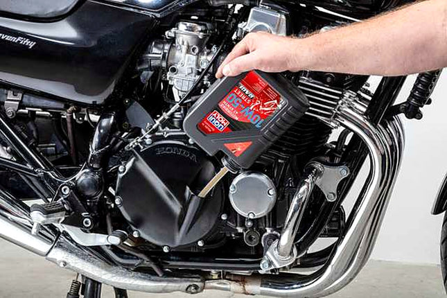 Liqui Moly Motorbike 4T Synth 10W-50 Street Race being poured into a motorcycle engine