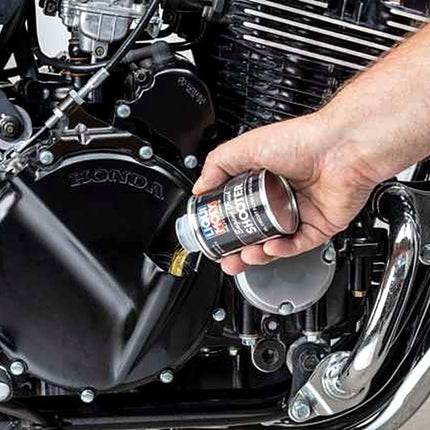 Liqui Moly Motorbike Engine Flush Shooter being poured into a motorcycle engine