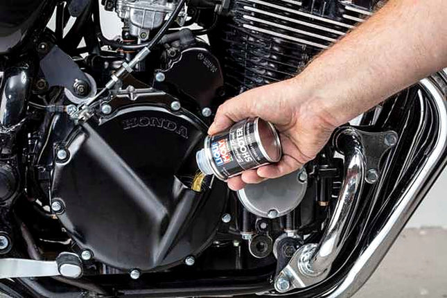 Liqui Moly Motorbike Engine Flush Shooter being poured into a motorcycle engine