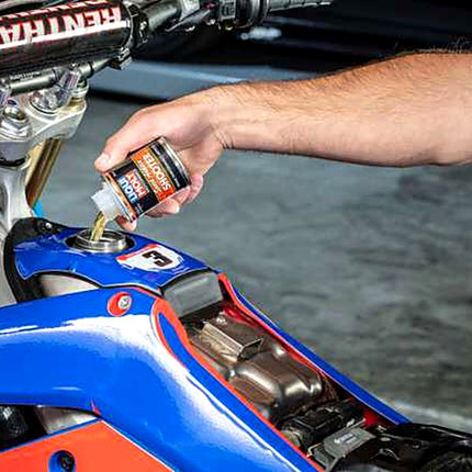 Liqui Moly Motorbike Speed Shooter being added to the fuel tank of a race motorcycle