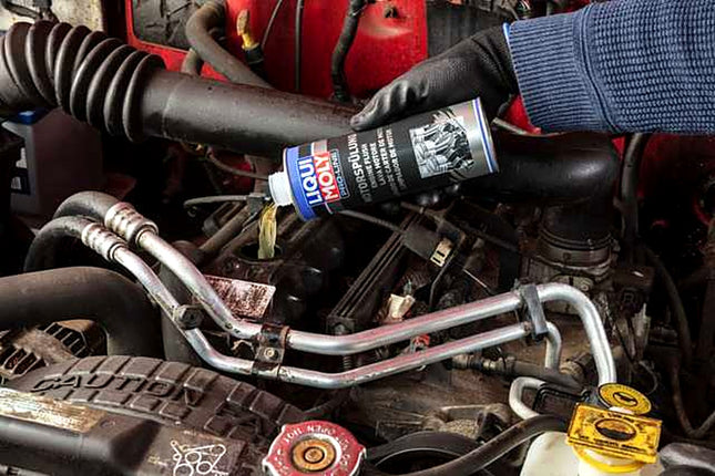Liqui Moly Pro-Line Engine Flush being poured into a car engine oil filler