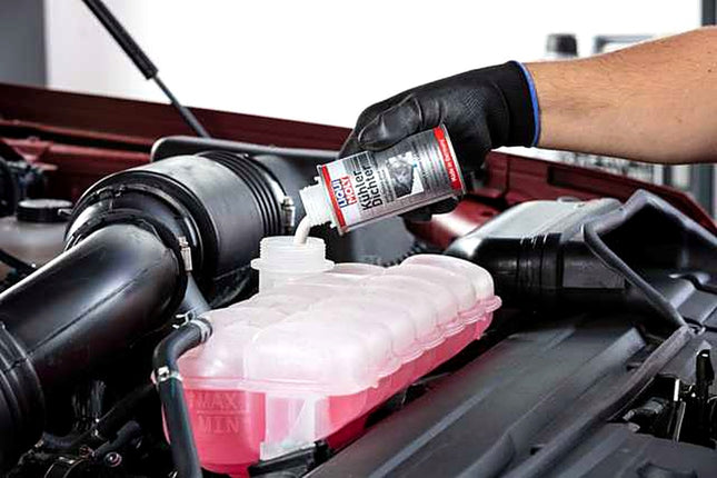 Liqui Moly Radiator Stop Leak being poured into a car coolant expansion tank