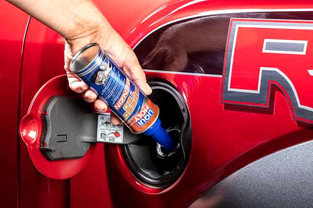 Liqui Moly Speed Tec Gasoline being poured into a car fuel filler