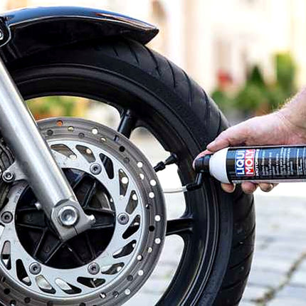 Liqui Moly Tyre Inflator and Sealer being used on a motorcycle wheel
