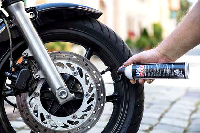 Liqui Moly Tyre Inflator and Sealer being used on a motorcycle wheel