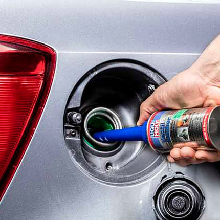 Liqui Moly Valve Clean being poured into a car fuel filler