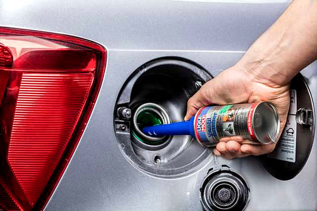 Liqui Moly Valve Clean being poured into a car fuel filler