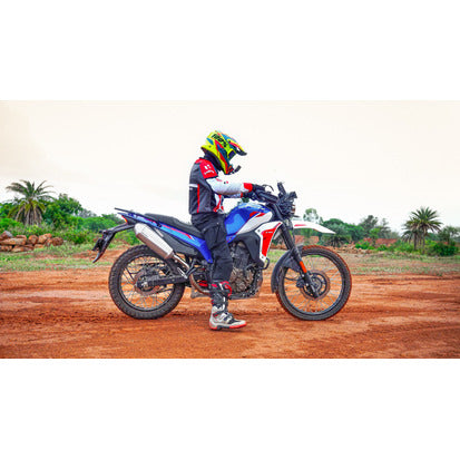 Rider beside a Hero XPulse 210 with the Powerage slip-on exhaust fitted